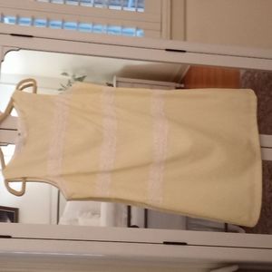 Beautiful dress seer sucker fabric in pale yellow with white lace decorations.